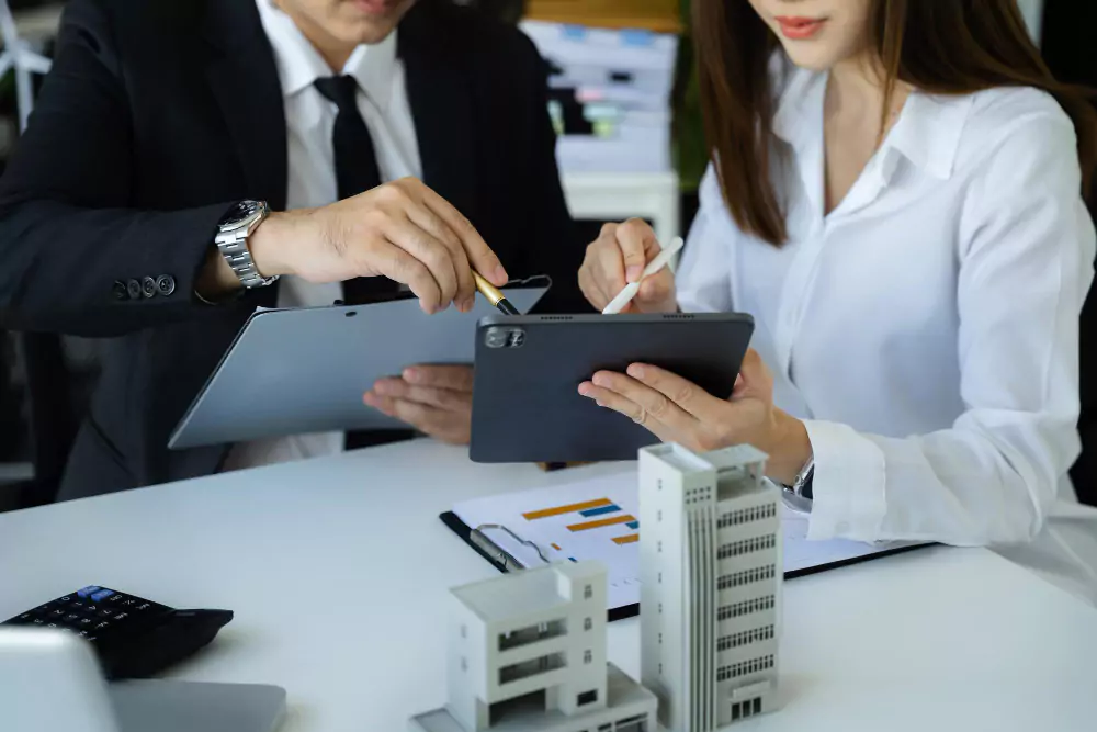 businessman-working-as-team-discussing-data-working-tablet-laptop-desk-office-1-6576b7065f875